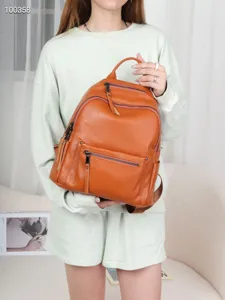 Stylish brown genuine leather women backpack with multi zipper pockets for daily travel use.