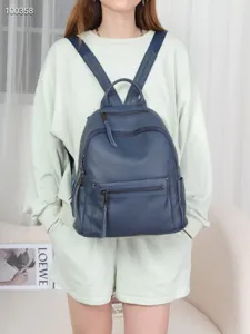 Leather backpack detail view, casual multi-pocket design, stylish daily travel bag accessory.