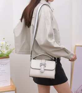 Detailed view of women's stylish leather crossbody bag featuring flap and metal lock.