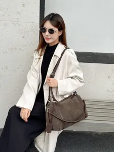 Detail view of the large capacity casual commuting shoulder bag in stylish brown suede finish.