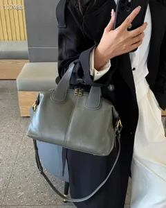 Detailed view of the genuine leather dumpling handbag showing premium oil-wax texture and stitching.