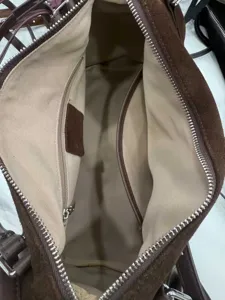 Spacious brown suede shoulder bag interior detail showing durable lining and pockets.