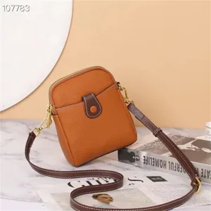 Genuine leather mini crossbody phone bag, stylish brown cowhide shoulder bag for women.