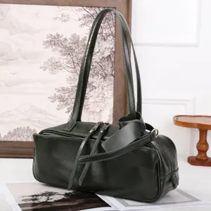 Detailed view of the dark green vegetable-tanned cowhide boston bag with dual straps.