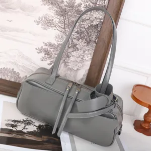 Minimalist grey cowhide bowling bag, stylish Boston handbag with double handles and large capacity.