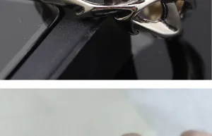 Close-up detail of retro gothic thorn ring for men, vintage antique silver open band design.