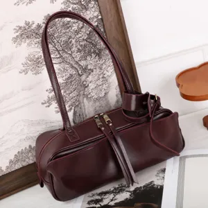 Minimalist vegetable-tanned leather bowling bag, stylish boston shoulder bag for women.