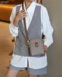 Minimalist leather crossbody phone bag with adjustable strap, compact and stylish everyday wear.
