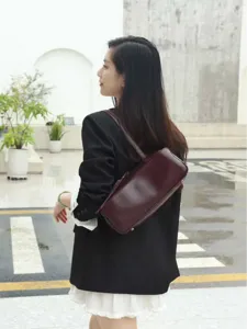 Minimalist leather bowling bag for women, stylish solid color shoulder handbag for daily fashion.