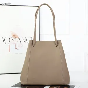 Detailed view of the vintage leather bucket tote bag, showcasing texture and handle design.