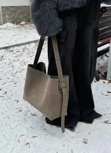 Detail view of khaki suede shoulder tote bag, soft texture and wide strap for daily commute.