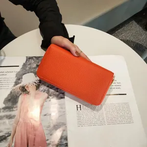 Orange pebbled leather long zip-around wallet for women, stylish multi-slot clutch purse.