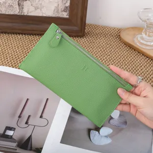 Green genuine leather long wallet for women with top zipper and stylish minimalist design.