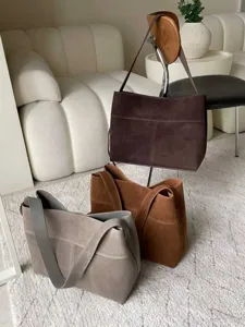 Detailed view of large capacity suede shoulder tote bag in dark brown, camel and grey colors.