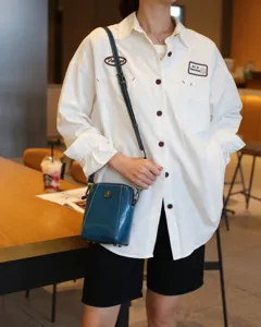 Blue oil wax leather crossbody phone bag for women, retro small shoulder bag with metal decor.