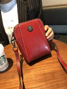 Red oil wax leather crossbody bag with metal flower decor, stylish women phone shoulder bag.