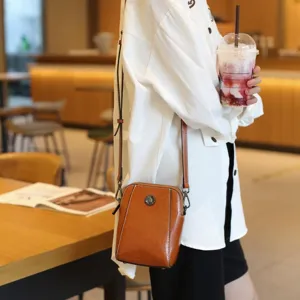 Brown leather crossbody phone bag for women, stylish small shoulder bag with strap.