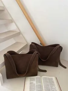 Close-up detail of large capacity brown suede tote bag, minimalist commuter style design.