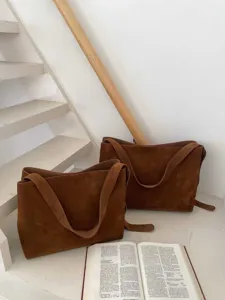 Detail view of a brown suede tote bag, large capacity Maillard style shoulder commuting bag.