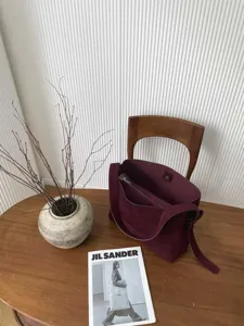 Detailed view of the burgundy suede tote bag showcasing soft texture and large capacity daily use.