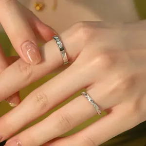 Close-up detail shot of exquisite silver couple rings featuring sparkling pave diamond accents.