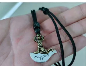Vintage vajra axe pendant necklace for men, unique ethnic style metallic amulet jewelry detail.