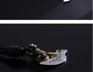 Vintage vajra axe pendant detail shot, retro style metal necklace for men with black cord.