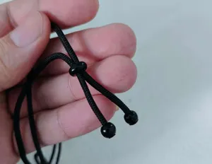 Adjustable black braided necklace cord with sliding beads, durable rope for pendants.