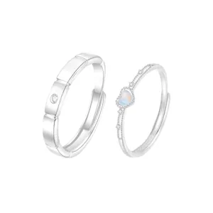 Detailed view of the couple ring set, featuring a geometric zirconia band and a heart stone ring.