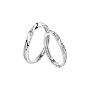 Minimalist silver couple rings set with open adjustable design and sparkling stone details.