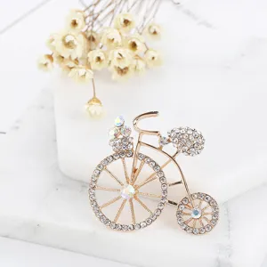 Exquisite rhinestone bicycle brooch detail, elegant gold tone metal craftsmanship for outfits.