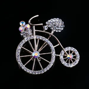 Detailed shot of exquisite rhinestone bicycle brooch pin for women collar clothing decor.