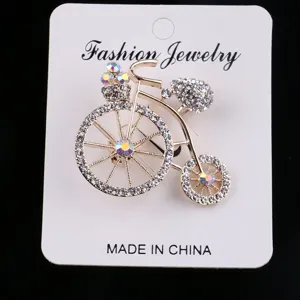 Detailed view of rhinestone bicycle brooch, elegant crystal lapel pin clothing accessory.