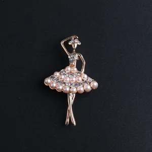 Exquisite rhinestone and faux pearl ballerina brooch detail, elegant metallic accessory.