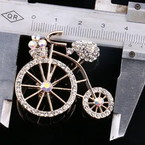 Gold bicycle brooch pin with sparkling rhinestones, elegant suit collar dress accessory.