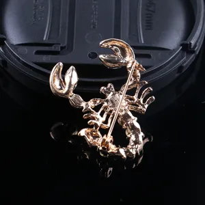 Gold tone scorpion brooch back detail showing secure pin clasp and durable metal construction.