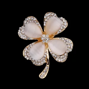 Elegant four-leaf clover brooch pin with white cat-eye stone and sparkling rhinestones for women.