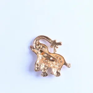 Gold alloy elephant brooch pin back view detail, elegant animal costume jewelry accessory.