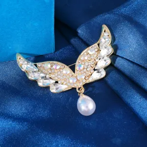Close-up detail view of the exquisite angel wing brooch featuring sparkling clear crystals and pearl drop.