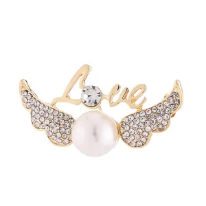 Broche élégante ailes d'ange perle strass dorée accessoire bijou vêtement femme mode.