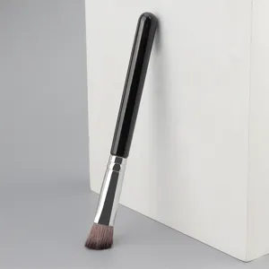 Detailed shot of angled highlighter brush with soft bristles and sleek black handle.