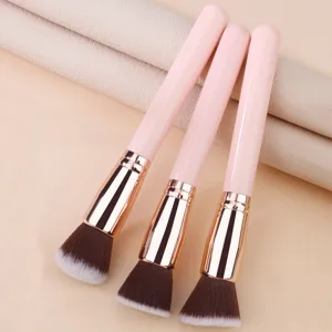 Brocha de maquillaje profesional con mango rosa y cerdas suaves para un difuminado perfecto.