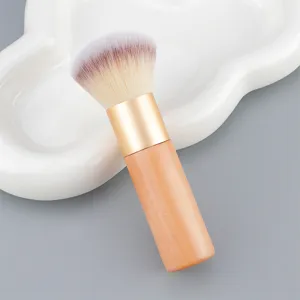 Close-up of makeup brush with soft bristles and wooden handle for smooth powder application.