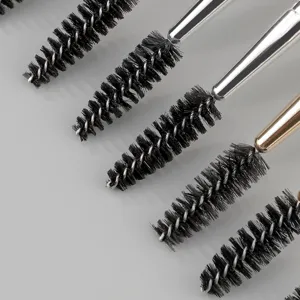 Detailed close-up of professional spiral eyelash makeup brushes with metal handles for eye beauty.