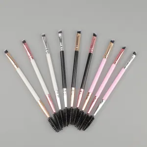 Close-up detail of dual-ended eyebrow brush and spoolie brush with colorful handles and ferrule.