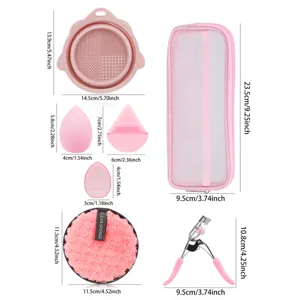 Detailed view of makeup tool set with silicone bowl, beauty sponges, mesh bag and eyelash curler.