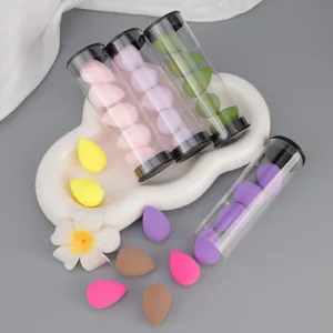 Detailed view of colorful mini makeup sponge blenders in transparent storage tubes.