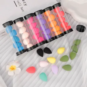 Mini makeup sponge set, detailed view of colorful teardrop cosmetic puffs in clear tubes.
