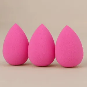 Close-up of pink teardrop makeup sponges, soft cosmetic puff detail for smooth face blending.