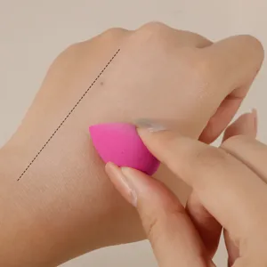 Mini makeup sponge detail shot, pink teardrop beauty blender for precise eye makeup concealer.